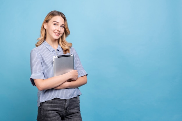 Front view beautiful woman holding a tablet