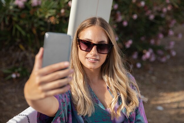 Front view of beautiful woman taking a selfie