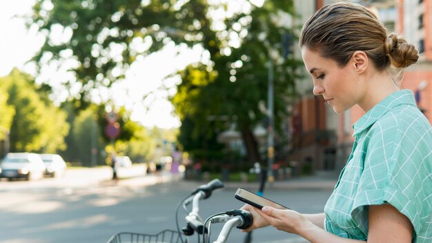 Front view of beautiful woman with bicycle