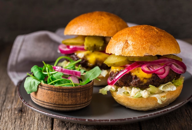 Front view beef burgers with pickles on cutting board