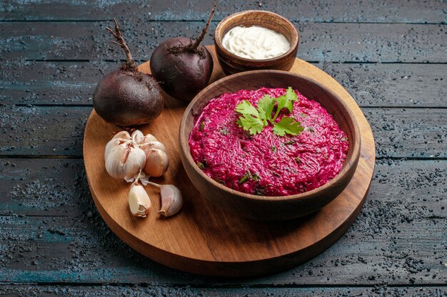 Front view beet salad with sour cream and garlic on dark desk