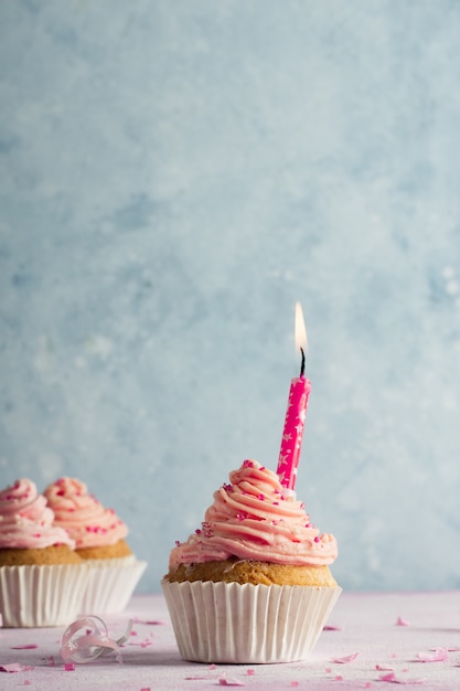 Free photo front view of birthday cupcake with copy space and lit candle