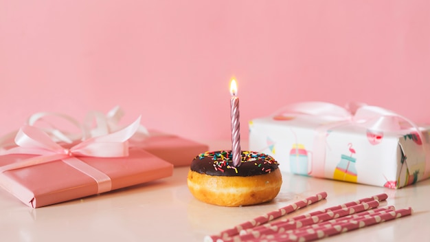 Front view birthday donut with lit candle