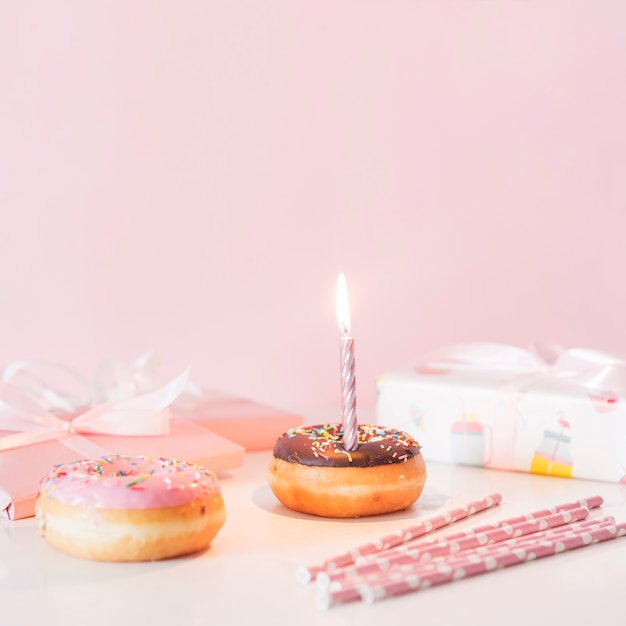 Free photo front view birthday donut with lit candle