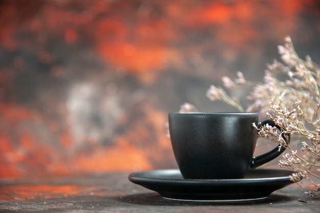 Front view black cup and saucer on dark red table with free space