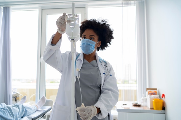 Front view black female doctor wearing mask