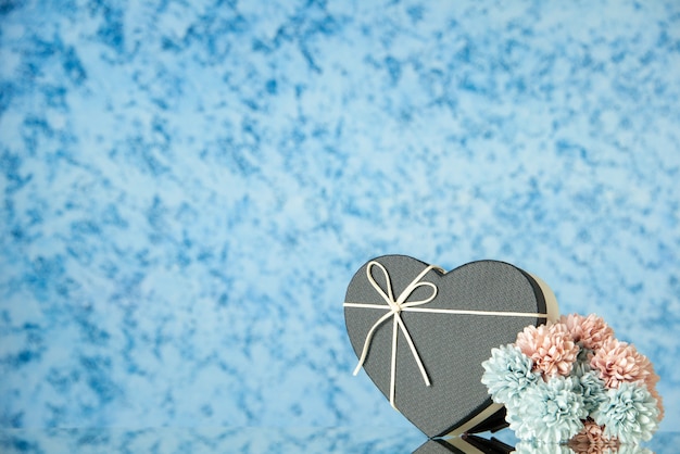 Free Photo front view of black heart shaped box flowers on blue blurred