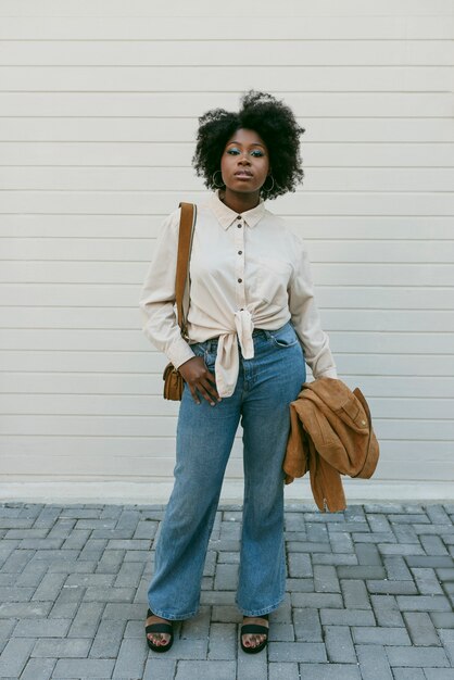 Front view black woman posing outdoors