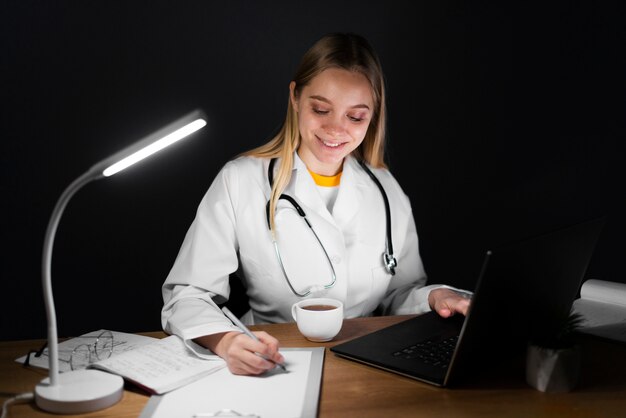 Front view of blonde woman doctor working