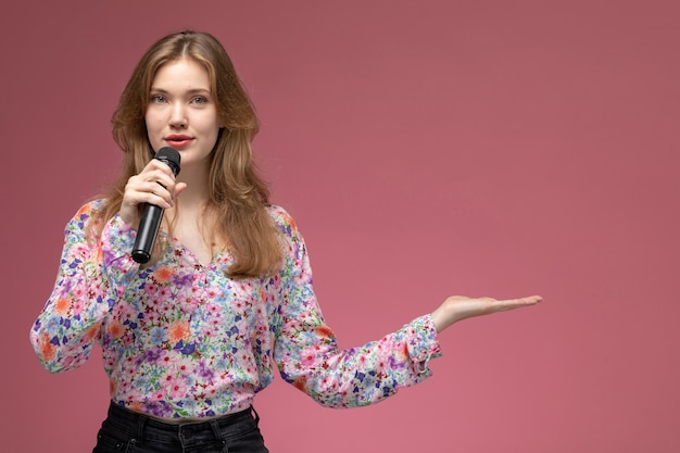 Free Photo front view blonde woman giving empty hand and talking to audience