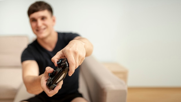 Free Photo front view blurred boy playing with a controller