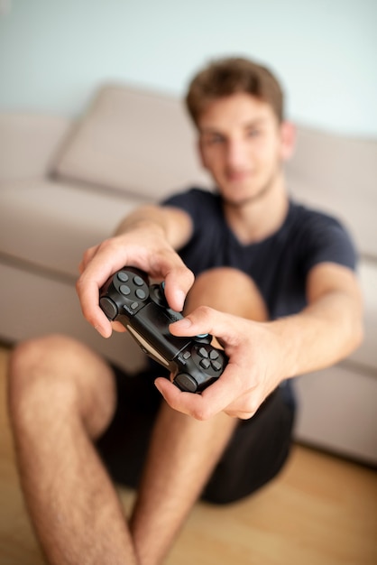 Front view blurred guy with game controller 