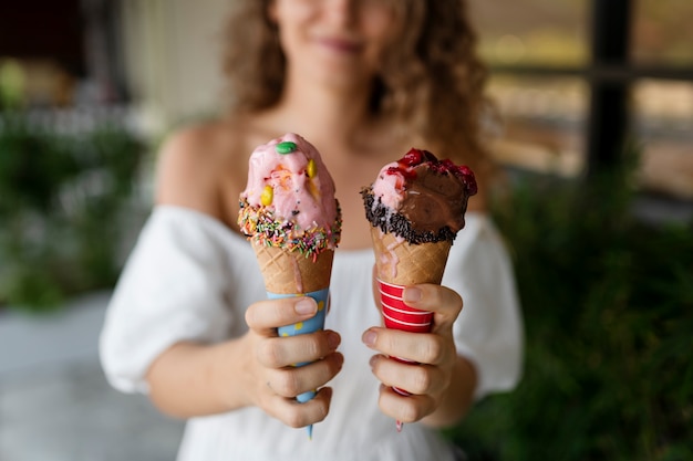 Free photo front view blurry woman holding ice cream