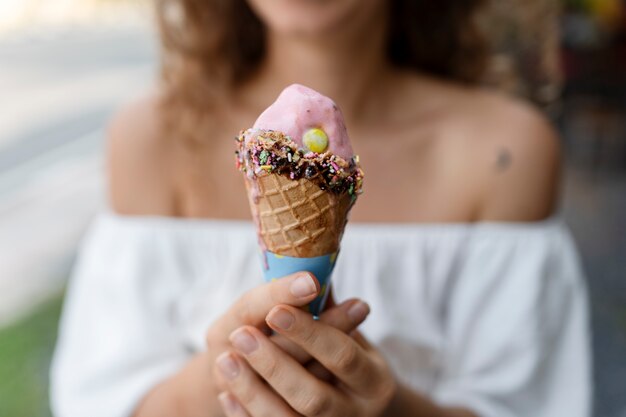 Front view blurry woman holding ice cream