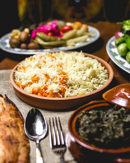 Front view boiled rice on a plate with boiled potatoes and pumpkin