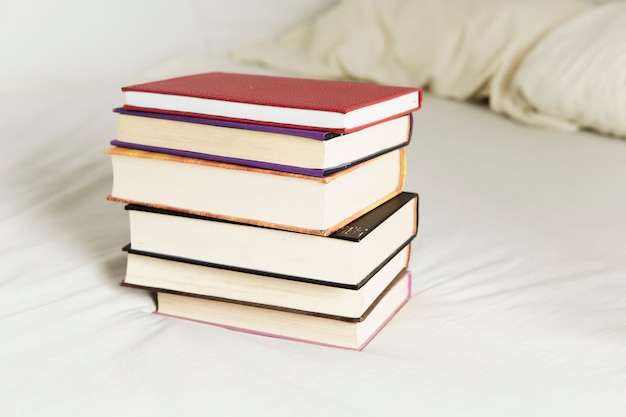 Free Photo front view of book arrangement on bed