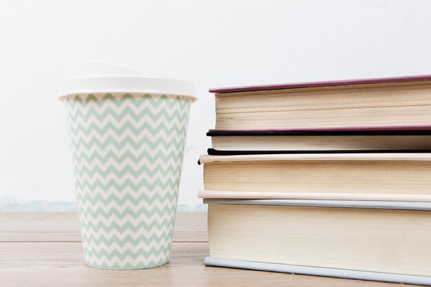 Front view of book arrangement and cup