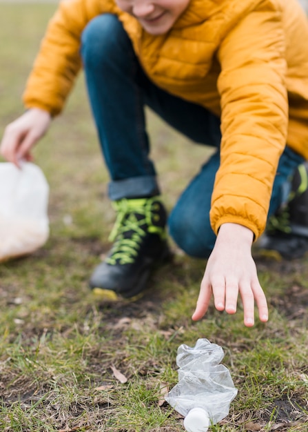 Front view of boy cleaning the ground