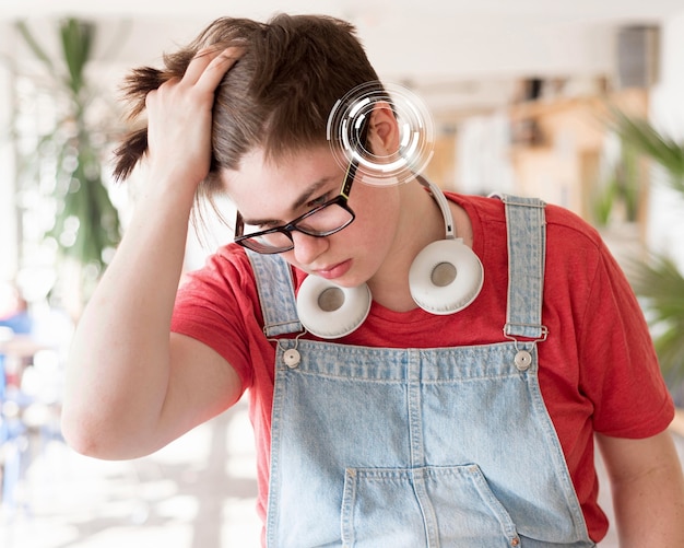 Free Photo front view boy experiencing hearing issues