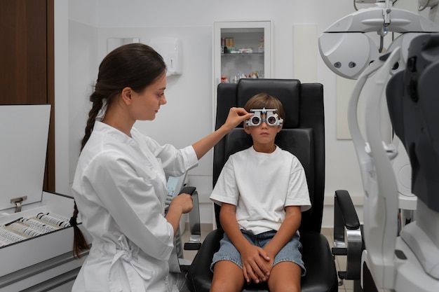 Free Photo front view boy at eye's checkup