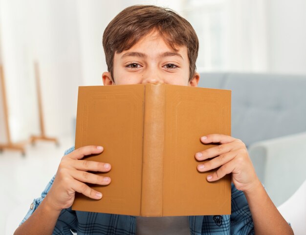 Front view boy at home reading