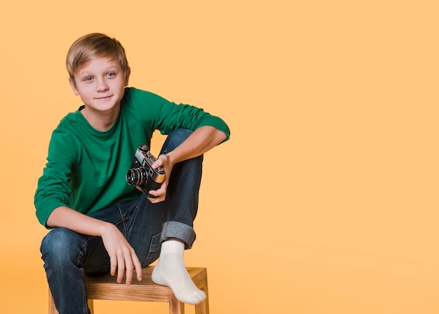 Free Photo front view of boy looking away with copy space