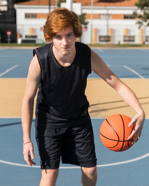 Free photo front view of boy playing basketball