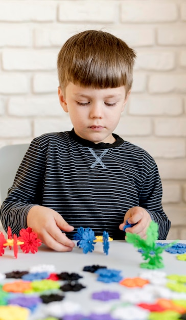 Free Photo front view boy playing indoors