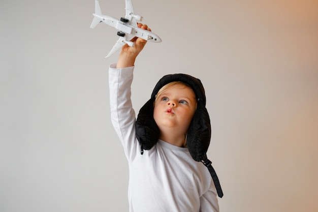 Front view boy playing with airplane