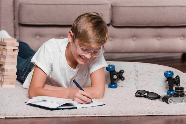 Front view of boy writing in an agenda