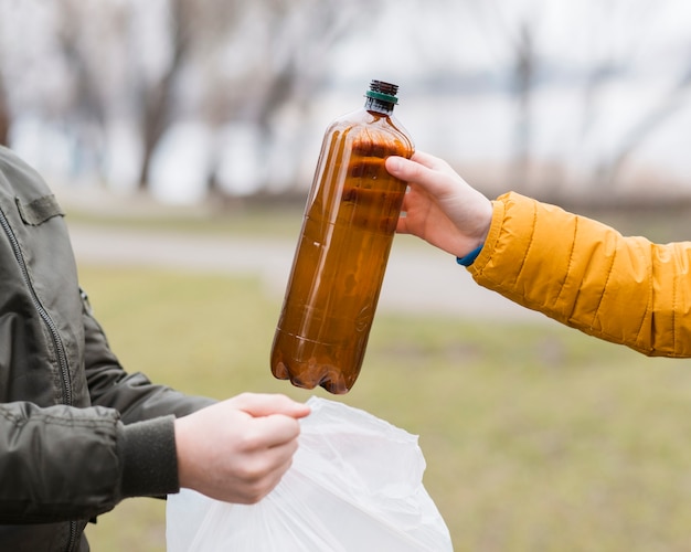 Front view of boys with plastic bag