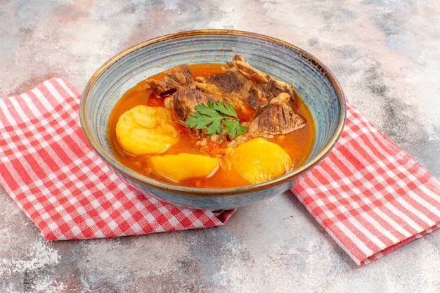 Front view bozbash soup kitchen towel on nude background azerbaijani cuisine