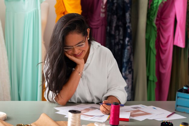 Front view brazilian woman working as clothing designer