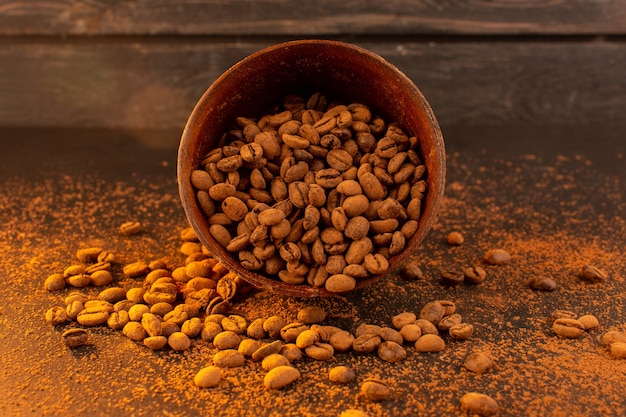 A front view brown coffee seeds inside brown plate on the brown coffee seed