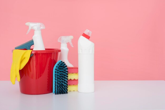 Front view of bucket with cleaning supplies and copy space