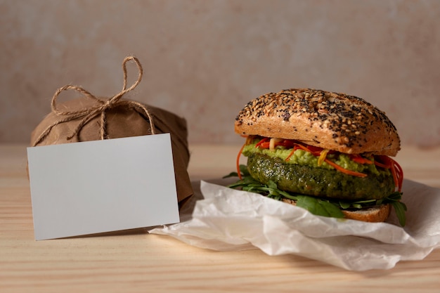 Free Photo front view burger with delivery package