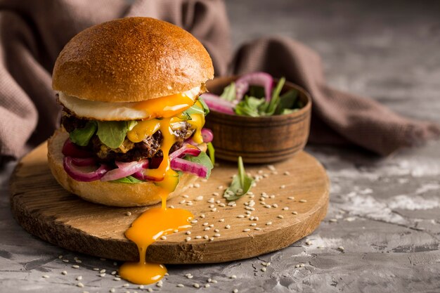 Front view burger with fried egg on cutting board