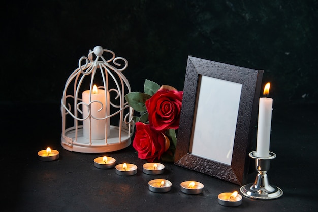 Free photo front view burning candles with picture frame as memory for fallen dark surface