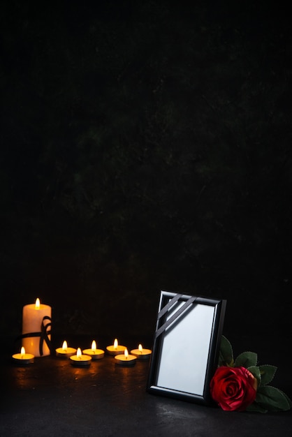 Free Photo front view of burning candles with picture frame on a dark surface