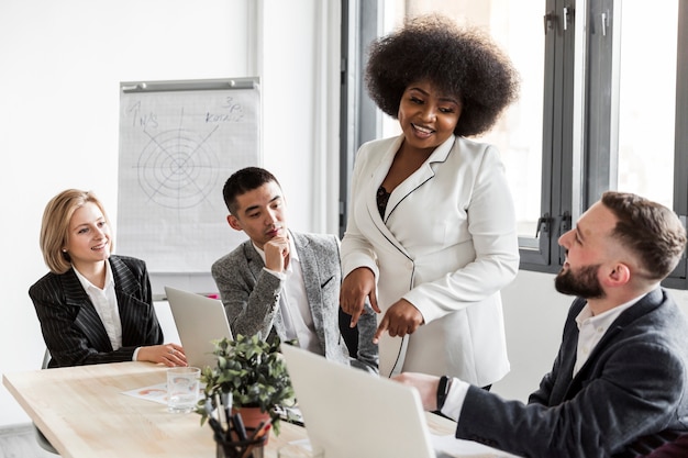 Free photo front view of business people in meeting