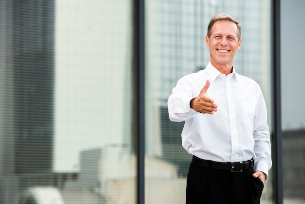 Front view businessman holding his hand out