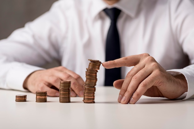 Front view of businessman in suit and tie with coins