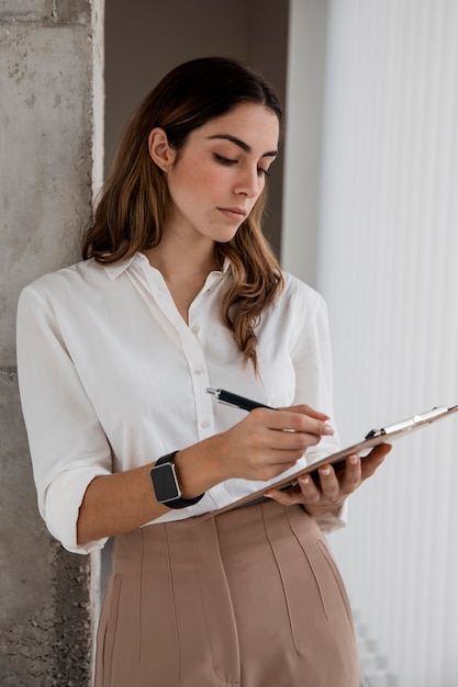 Front view of businesswoman with clipboard