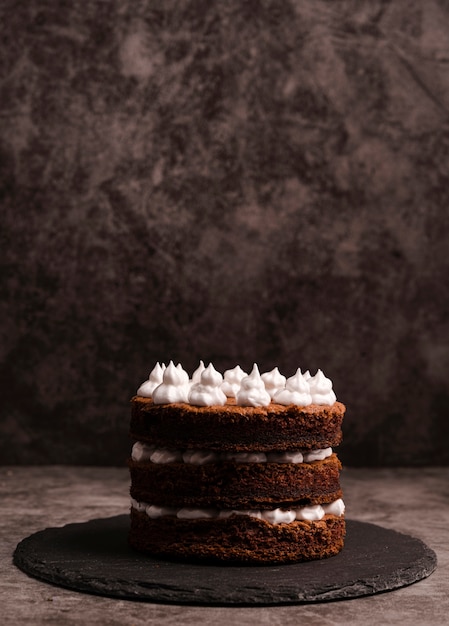 Free photo front view of cake on slate with copy space