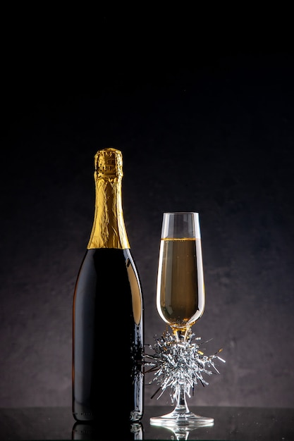 Front view champagne glass bottle on dark surface