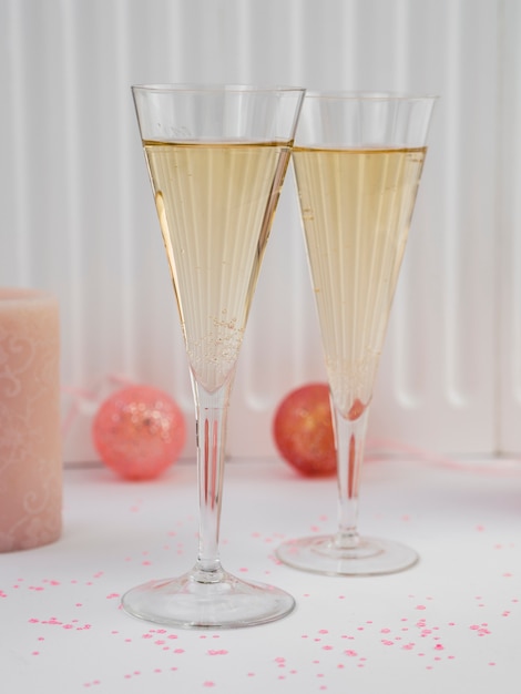 Front view of champagne glasses and pink globes