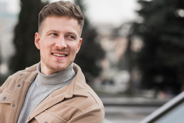 Front view of charming man posing outdoors