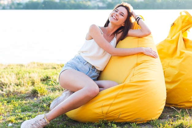 Free photo front view charming woman posing on beanbag