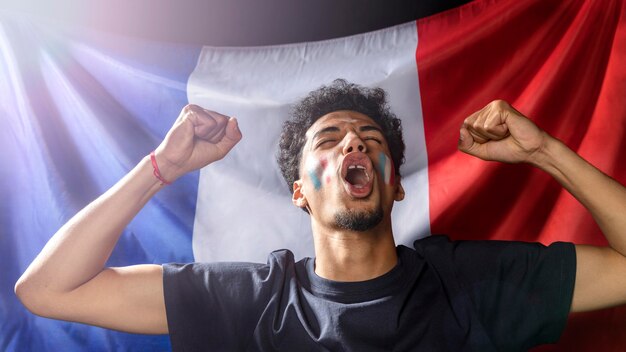 Front view of cheering man with french flag