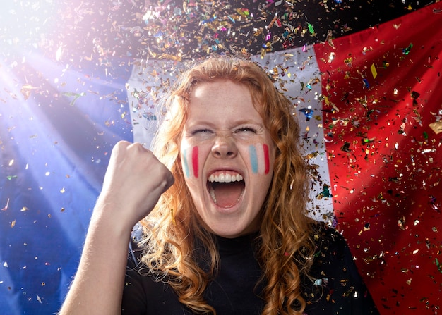 Free photo front view of cheering woman with french flag and confetti